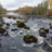 A view of the Ämmäkoski rapids in Varkaus, Finland. Water, rocks, forests in the background.