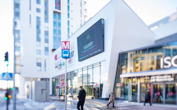 A public transport stop outside a shopping center