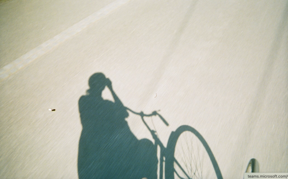 Student on a bicycle in the sun