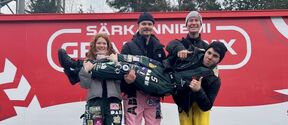 3 students at Särkänniemi carrying one student
