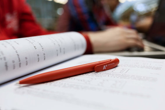 Red pen on open book
