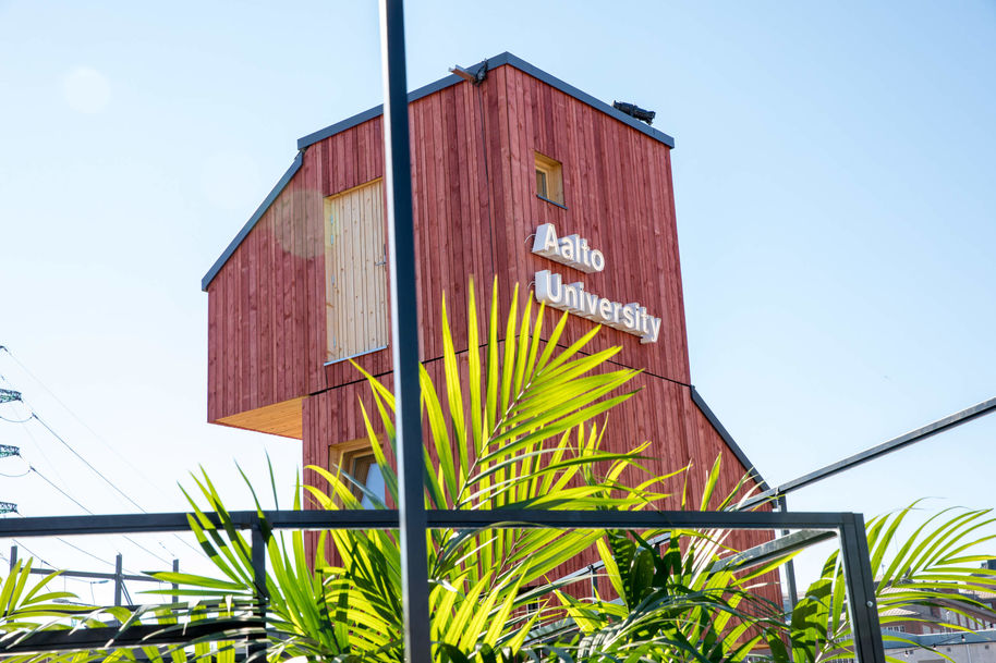 Wood building with Aalto University logo on side