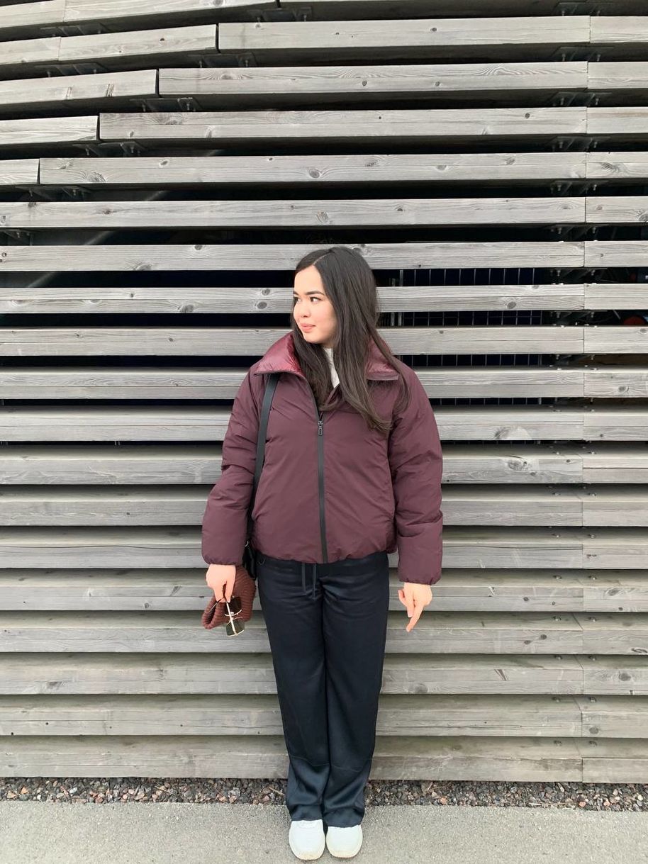 Madina posing next to Loyly's wall 