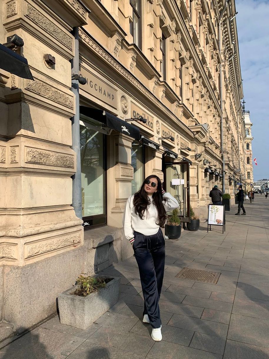 Madina posing in front of a luxurious shop