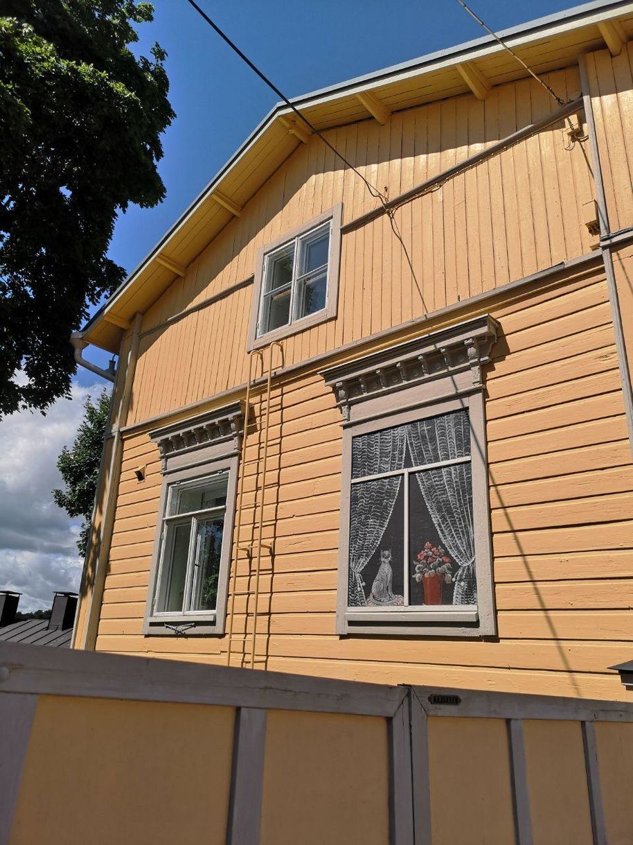 On some of the house walls, you can find colorful paintings. In many windows, there are Moomin figures and small decorations.