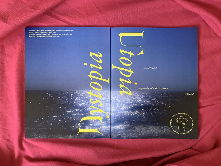 2 pieces of the Torso 2022 Issue 1 - “Utopia / Dystopia,” on a red sheet