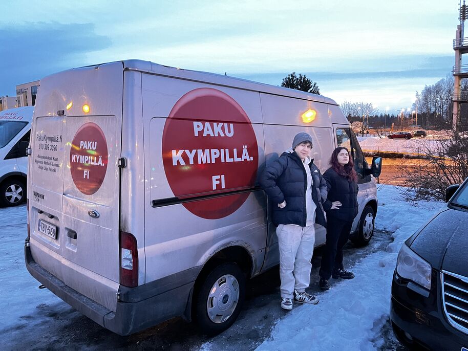 two students infront of a moving van