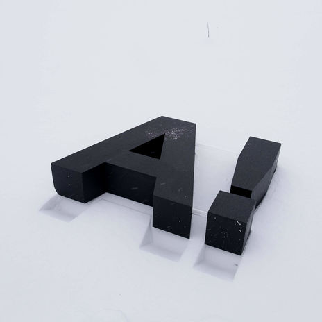 Large Aalto logo A with question mark on white surface